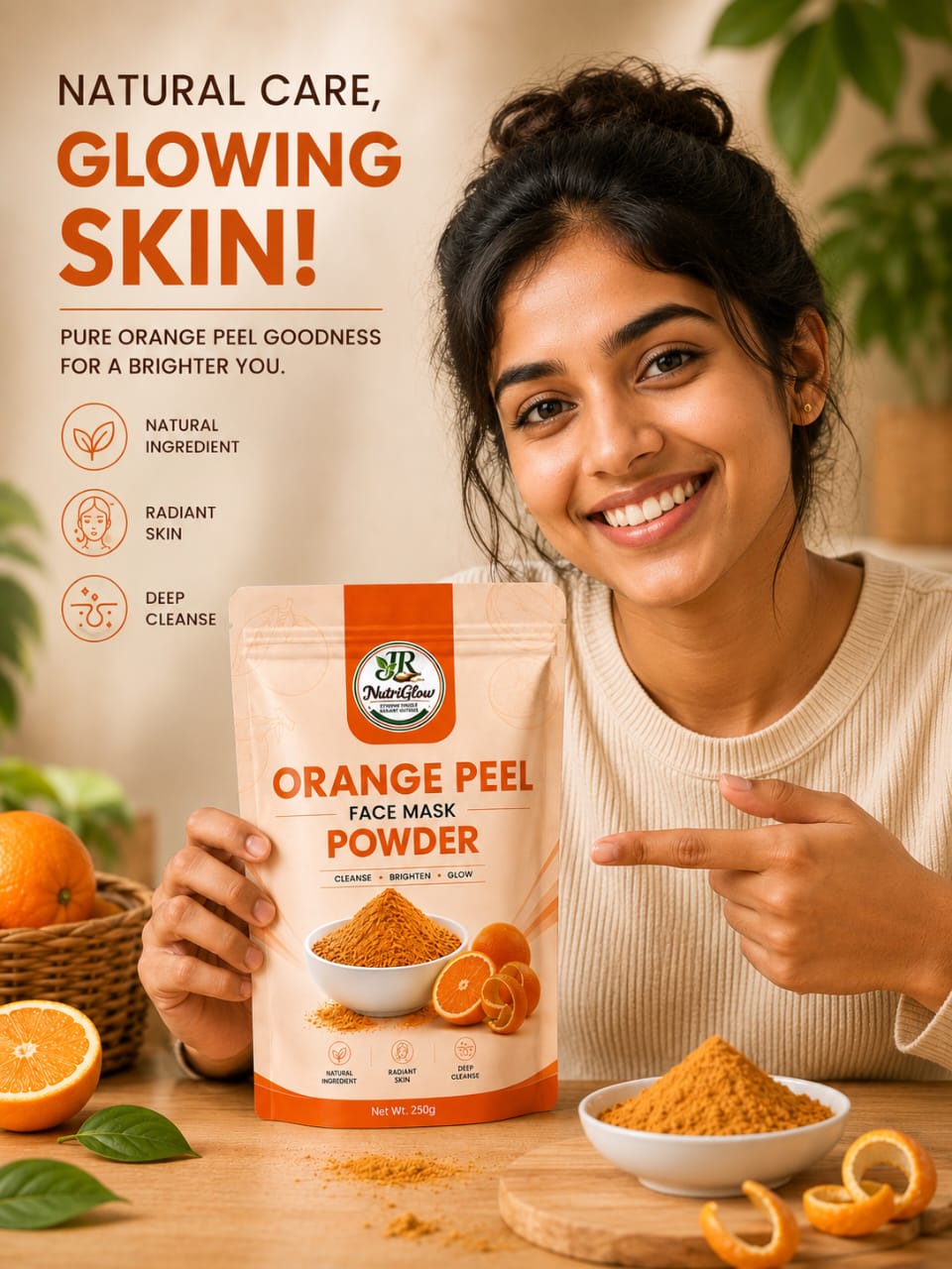 A smiling woman holds and points to a NutriGlow Orange Peel Face Mask Powder pouch, surrounded by fresh oranges, orange peels, leaves, and orange powder.